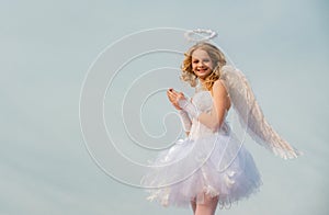 Cherub angel pray. The God of Love. Portrait of little curly blond Angel girl. Love card. Angel child girl with curly