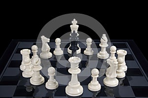Chess black king circled by white pieces
