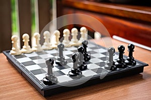 Chess black pawn invade attack white pawn for leader. photo