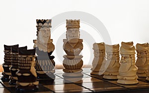Chess black and white king with pawns on the board