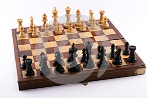 Chess board with black and white figurines on a white background