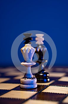 Chess board with chess pieces on blue background. Concept of business ideas and competition and strategy ideas. White and black