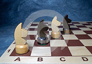 Chess board with figures. Wooden chess. Board games. Location of opponents. Counter strategy. Horses