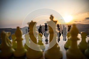 chess board game concept of business ideas and competition and strategy ideas. Chess figures on a chessboard outdoor sunset backgr