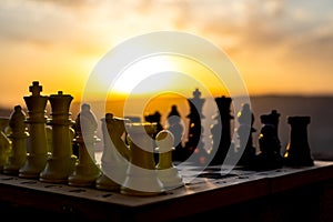 chess board game concept of business ideas and competition and strategy ideas. Chess figures on a chessboard outdoor sunset backgr