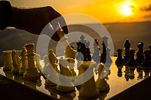 chess board game concept of business ideas and competition and strategy ideas. Chess figures on a chessboard outdoor sunset backgr