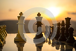 chess board game concept of business ideas and competition and strategy ideas. Chess figures on a chessboard outdoor sunset backgr