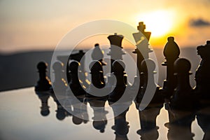 chess board game concept of business ideas and competition and strategy ideas. Chess figures on a chessboard outdoor sunset backgr