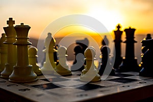 chess board game concept of business ideas and competition and strategy ideas. Chess figures on a chessboard outdoor sunset backgr