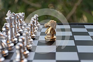 Chess board game. A knight faces all the enemies. Leader with courage concept