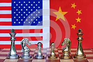 Chess board game pieces on USA and China flag background, trade war tension situation concept