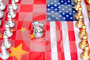 Chess board game pieces on USA and China flag background, trade war tension situation concept