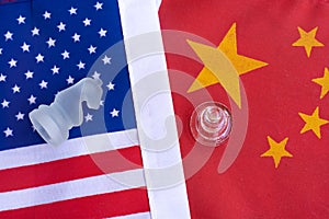 Chess board game pieces on USA and China flag background, trade war tension situation concept