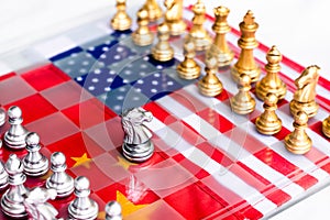 Chess board game pieces on USA and China flag background, trade war tension situation concept