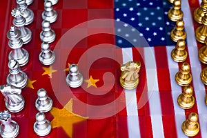 Chess board game pieces on USA and China flag background, trade war tension situation concept