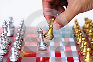 Chess board game pieces on USA and China flag background, trade war tension situation concept