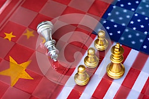 Chess board game pieces on USA and China flag background, trade war tension situation concept