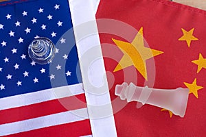 Chess board game pieces on USA and China flag background, trade war tension situation concept