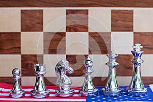 Chess board game pieces on USA and China flag background, trade war tension situation concept