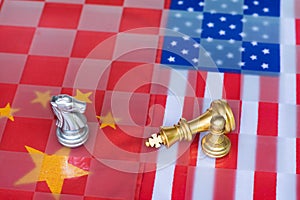 Chess board game pieces on USA and China flag background, trade war tension situation concept