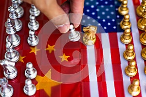 Chess board game pieces on USA and China flag background, trade war tension situation concept