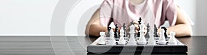 A chess board game with white and black chess pieces, business planning and risk management concepts compared to playing a chess