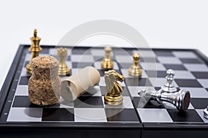 Chess Board isolated on white background. Golden and silver figures with several alcohol stoppers