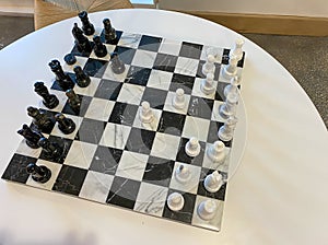 A chess board on a table in a recreation room at a luxury apartment building