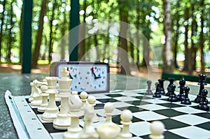 Chess and chess clock on the table in the Park