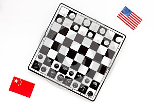 Chess competition concept. Chess board with figures near american and chinese flags on white background top view