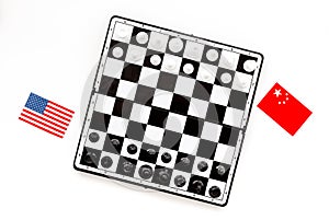 Chess competition concept. Chess board with figures near american and chinese flags on white background top view