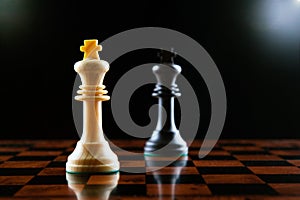 Chess duel of two kings on a black background