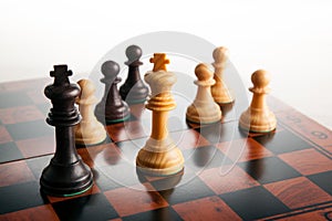 chess duel of two kings and pawns on a chessboard on a white background