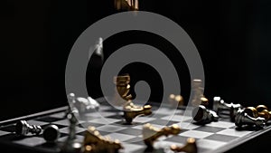 Chess falling on chess board loser concept Slow motion on dark background