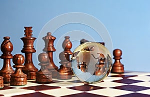 Chess figures against earth globe