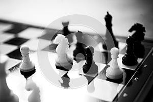 Chess figures, a chess game on a modern plastic chessboard