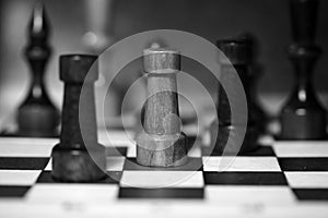 Chess figures on a chessboard in black and white