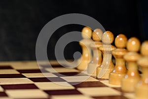 Chess figures on a chessboard on a dark background