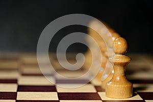 Chess figures on a chessboard on a dark background