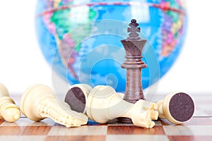 Chess figures in front of the globe