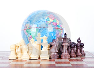 Chess figures in front of the globe