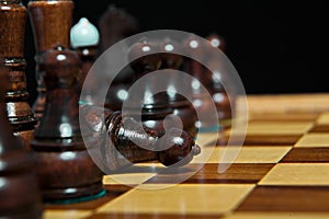 Chess figures on old wooden table