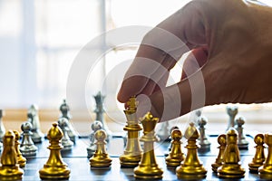 Chess game on chess board behind business man background. Business concept to present financial information and marketing strategy