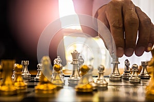 Chess game on chess board behind business man background. Business concept to present financial information and marketing strategy