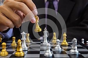 Chess game on chess board behind business man background. Business concept to present financial information and marketing strategy