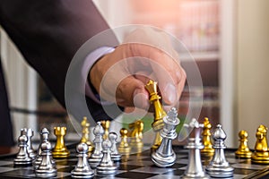 Chess game on chess board behind business man background. Business concept to present financial information and marketing strategy