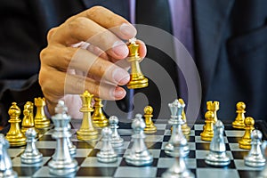 Chess game on chess board behind business man background. Business concept to present financial information and marketing strategy