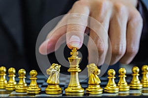 Chess game on chess board behind business man background. Business concept to present financial information and marketing strategy