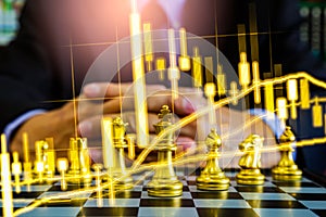 Chess game on chess board on stock market or forex trading graph chart for financial investment concept. Economy trends for