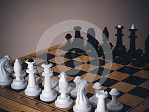 Chess game. Chess pieces on the game board. White and black. Tactical competition. Concept of a successful team work leader.